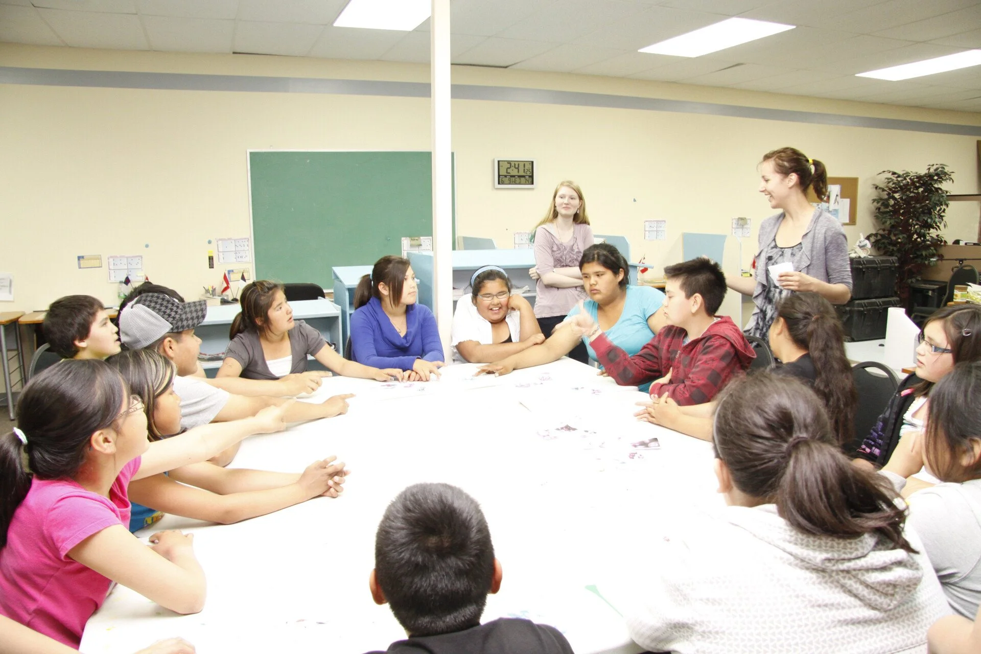Students and teachers around a classroom table at Dabwetamun Academy